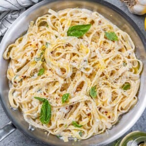 top view pan with lemon and ricotta creamy pasta with parsley garnishes