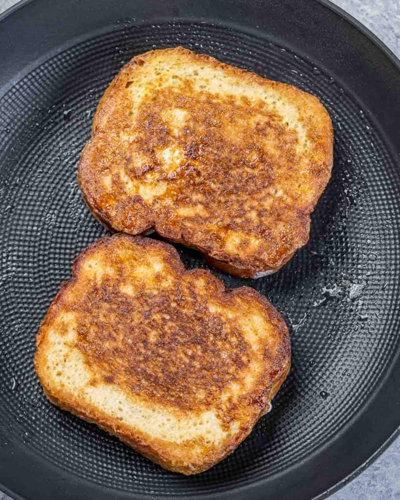 Cooking French toast in a pan.
