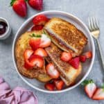 top view of sliced stuffed French toast with peanut butter and jelly in a round white bowl