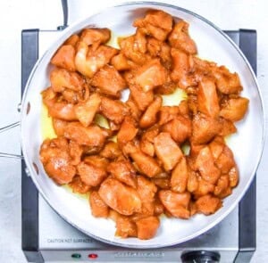 Cooking chicken bites in a pan.