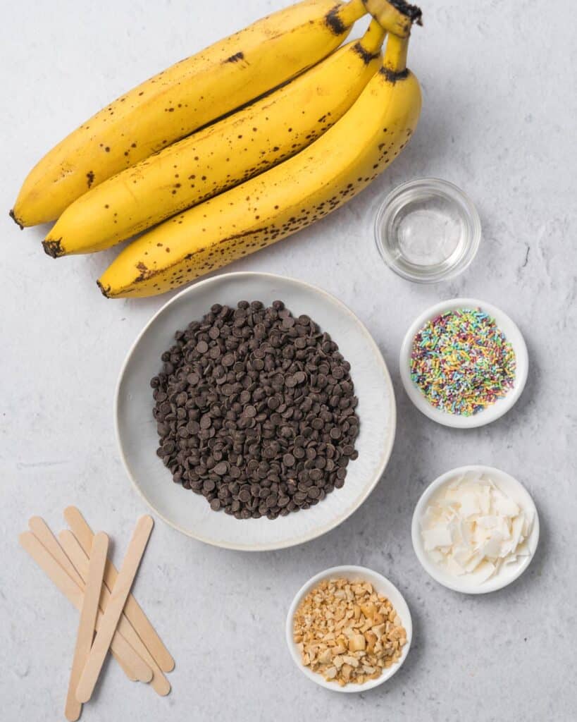ingredients to make banana pops. Bananas, chocolate chips, and sprinkles