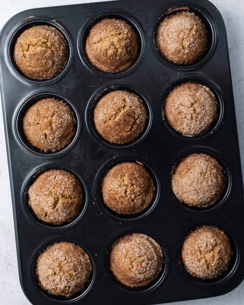 Baked cinnamon muffins in a pan.