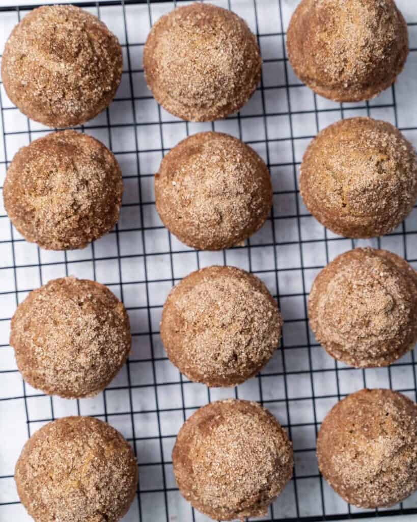 Cinnamon muffins on a wire cooling rack.
