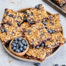 blueberry bars placed on a round plate.