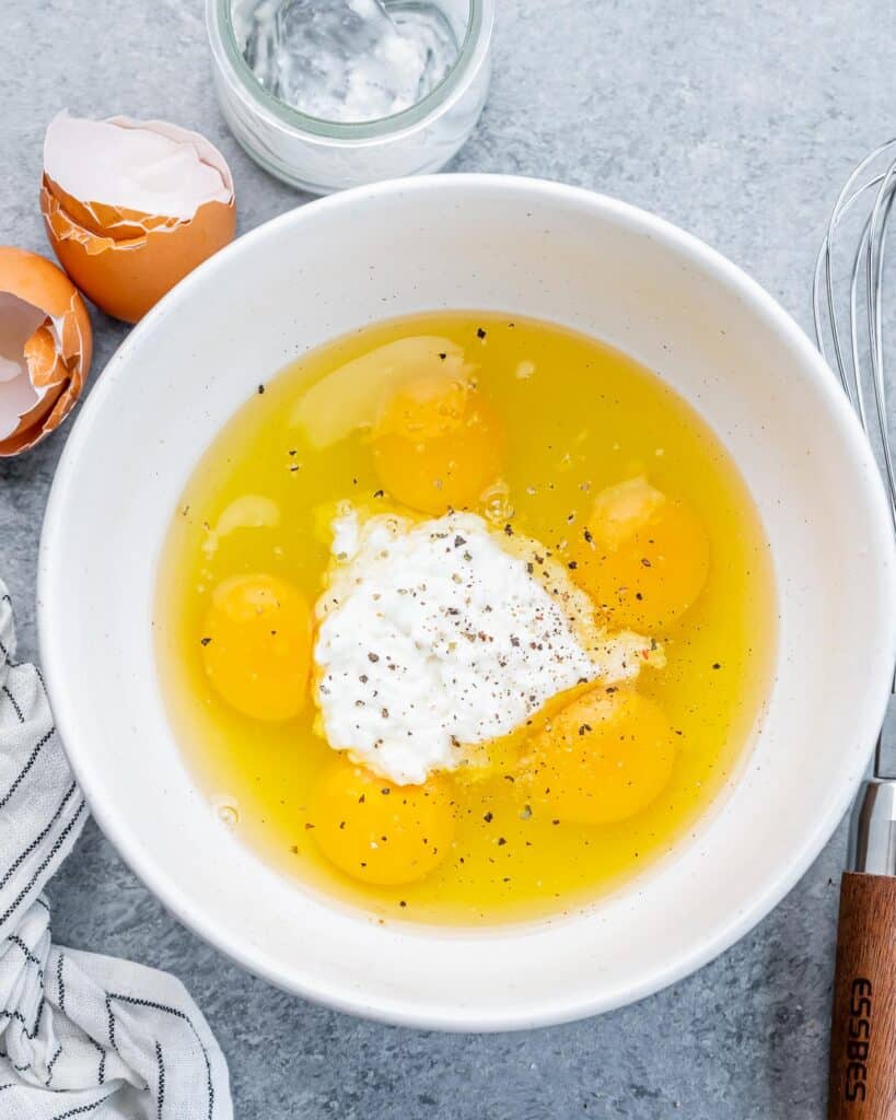 Eggs and cottage cheese in a white bowl.