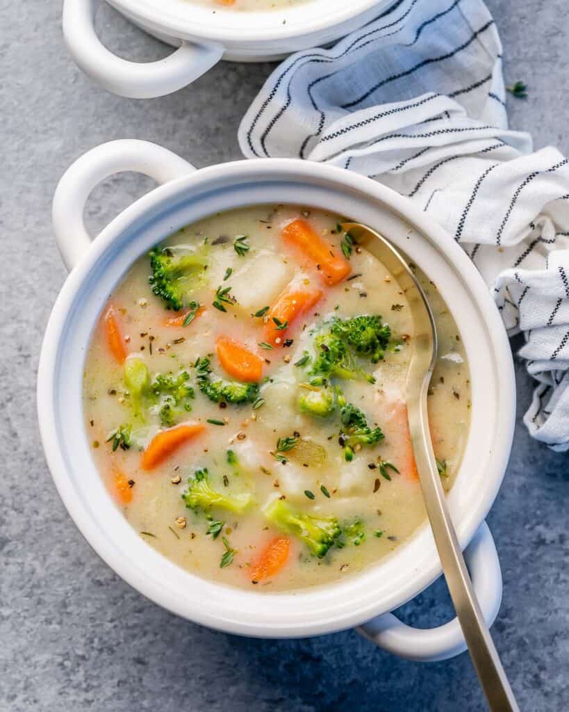 Vegetable soup in a bowl with a spoon.