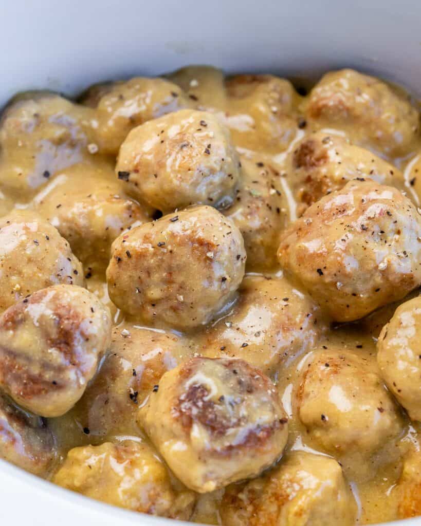 close up side shot of meatballs in a crockpot