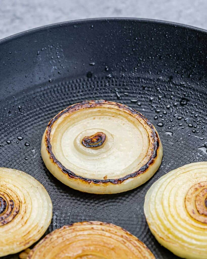 sauteed onion slices on a pan