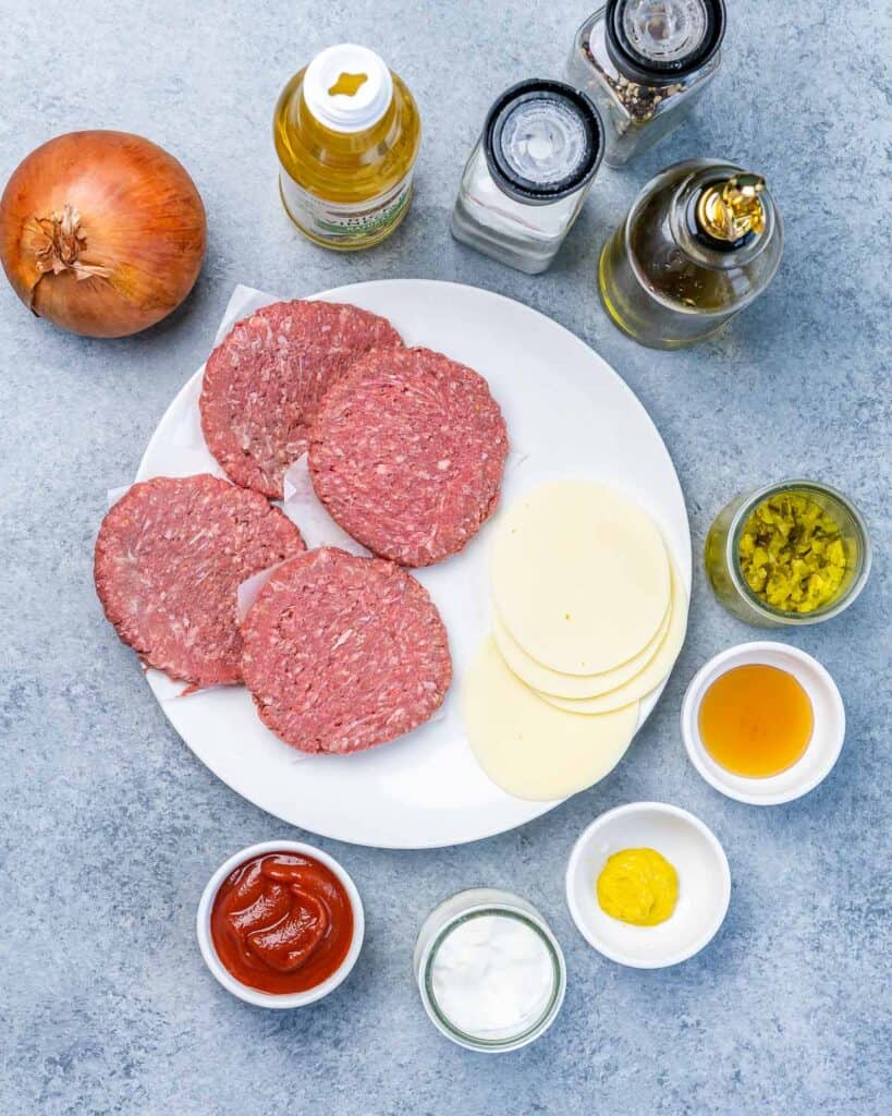 ingredients to make flying dutchman burger laid out on a flat surface,