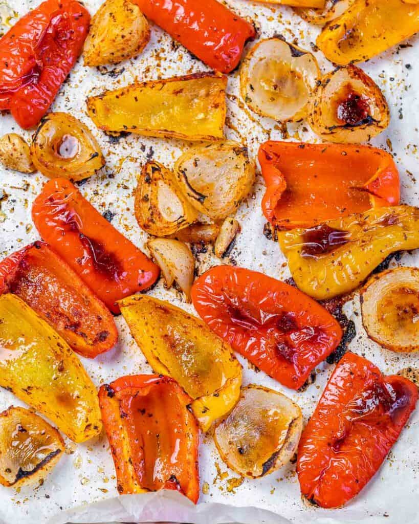 Roasted peppers and onions on a baking sheet.