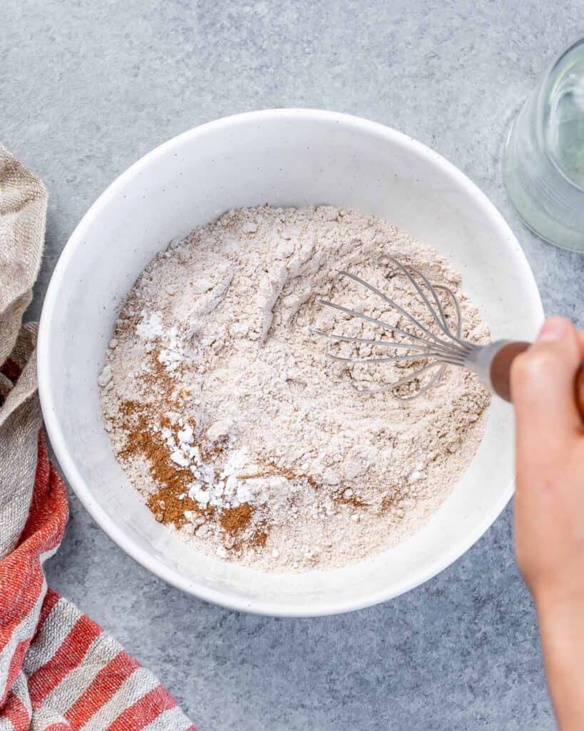 Whisking flour with cinnamon and baking powder.