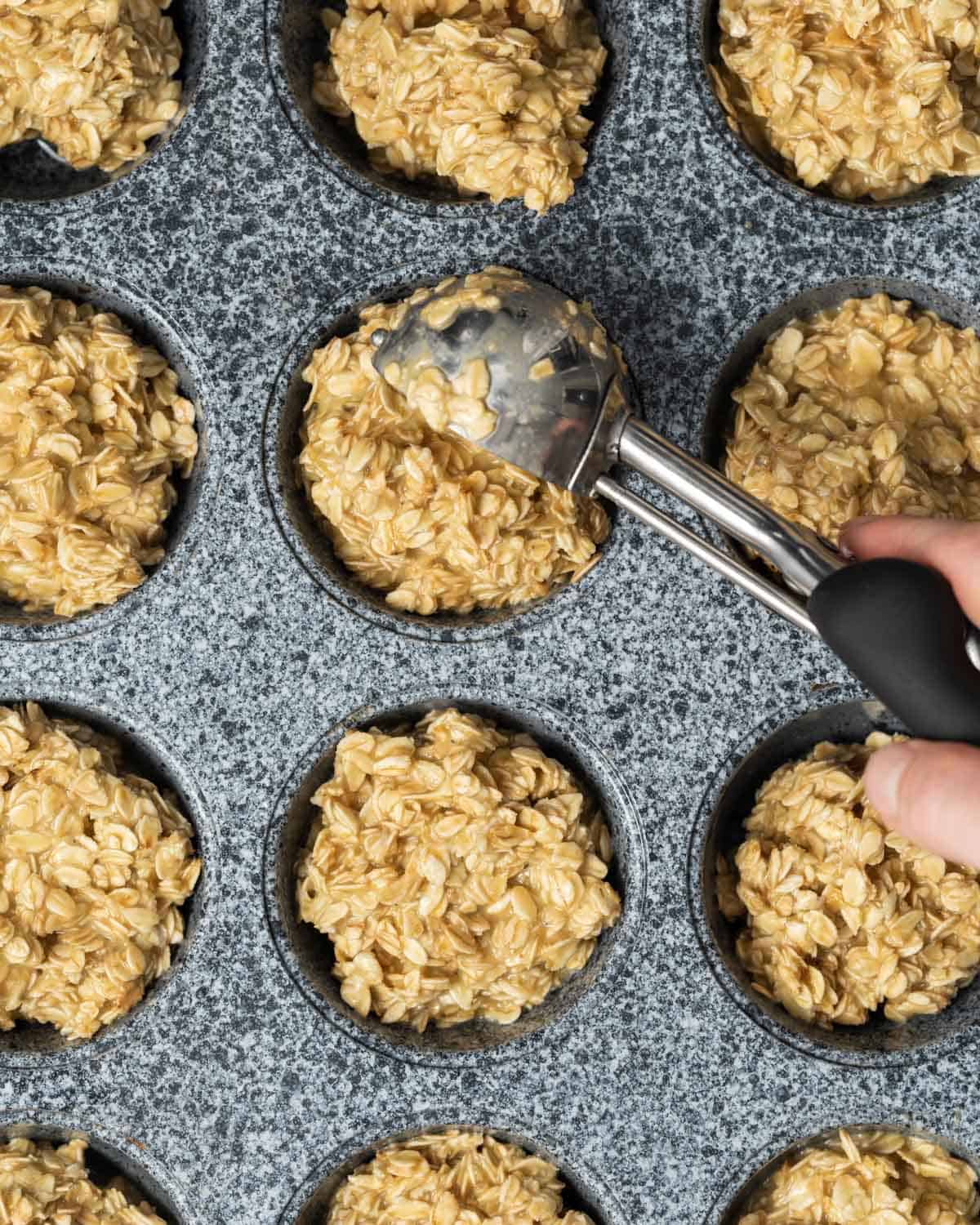 protein oatmeal batter added to a muffin pan.