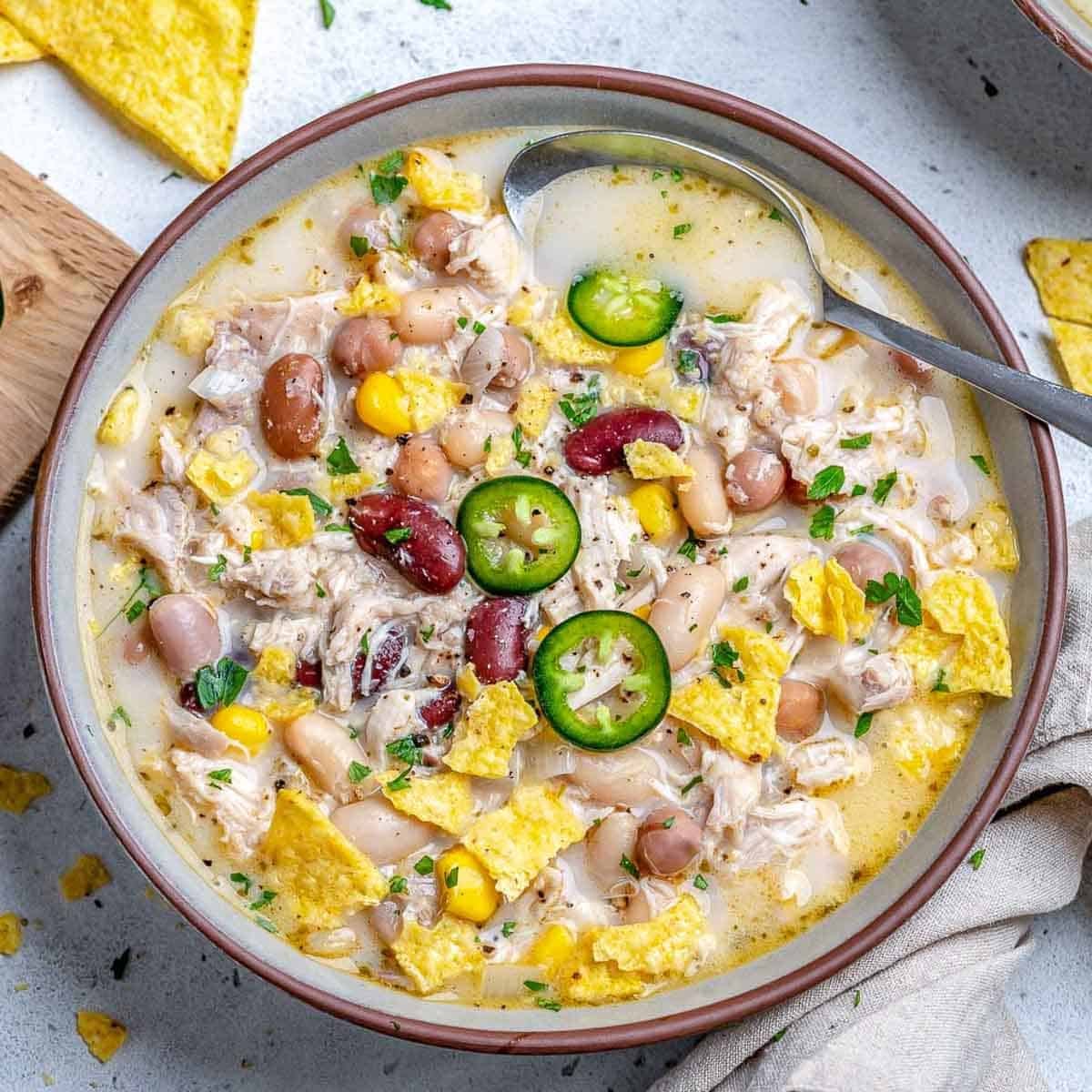 a bowl with white chicken chili with spoon in bowl.