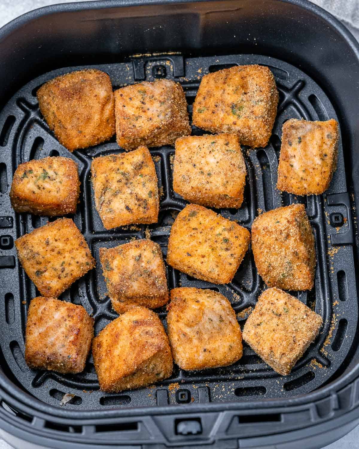 Salmon cooking in an air fryer.