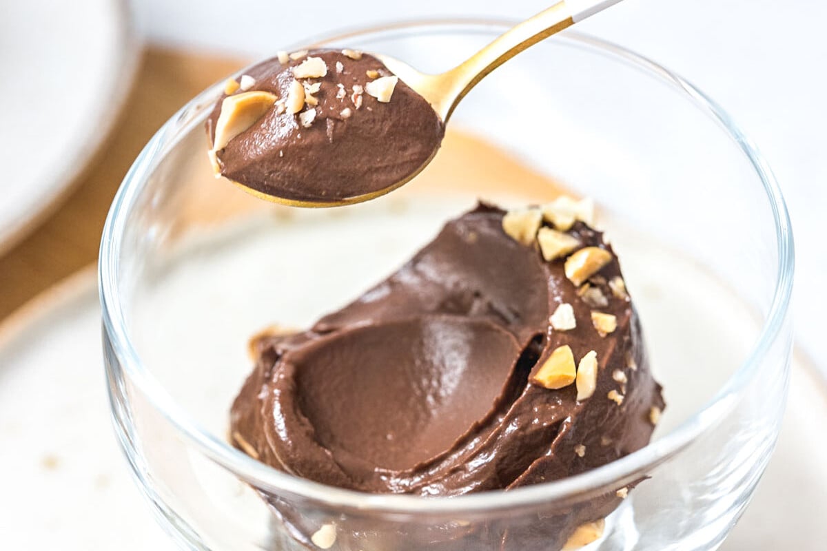 Using a spoon to take a serving of chocolate avocado ice cream.