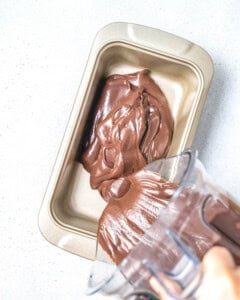 pouring the avocado ice cream mixture into a cake pan.