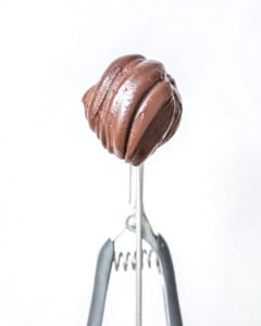 Single scoop of avocado ice cream in a scooper.