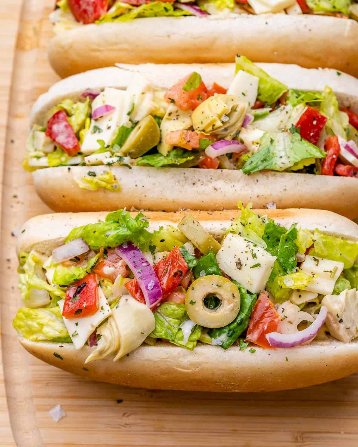 Overhead shot of buns filled with chopped Italian salad.