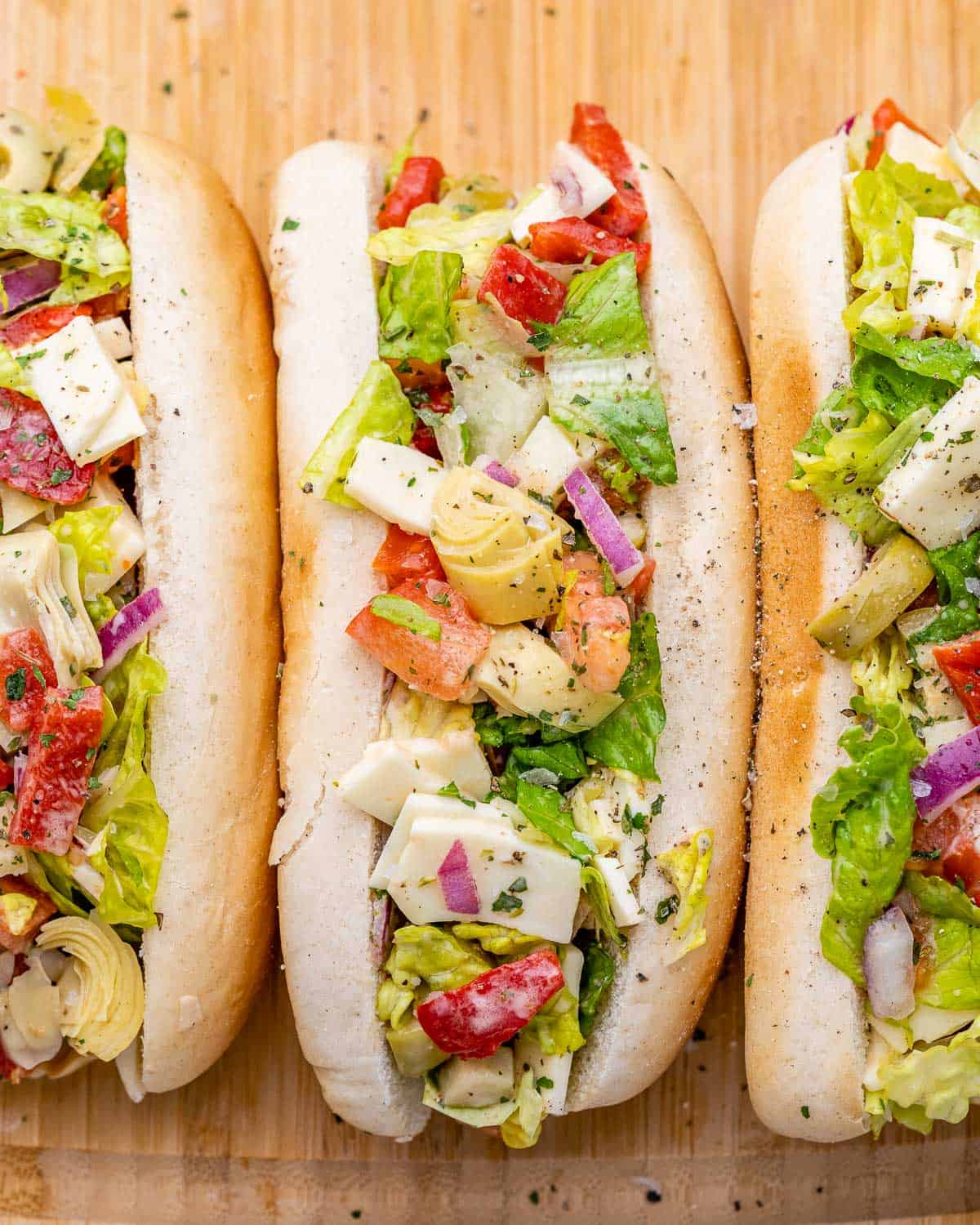 Chopped Italian salad served on a hot dog bun.