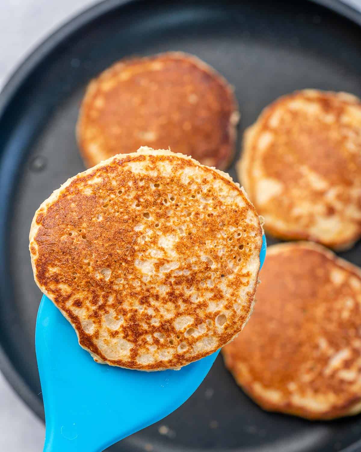 Flipping pancakes with a spatula.