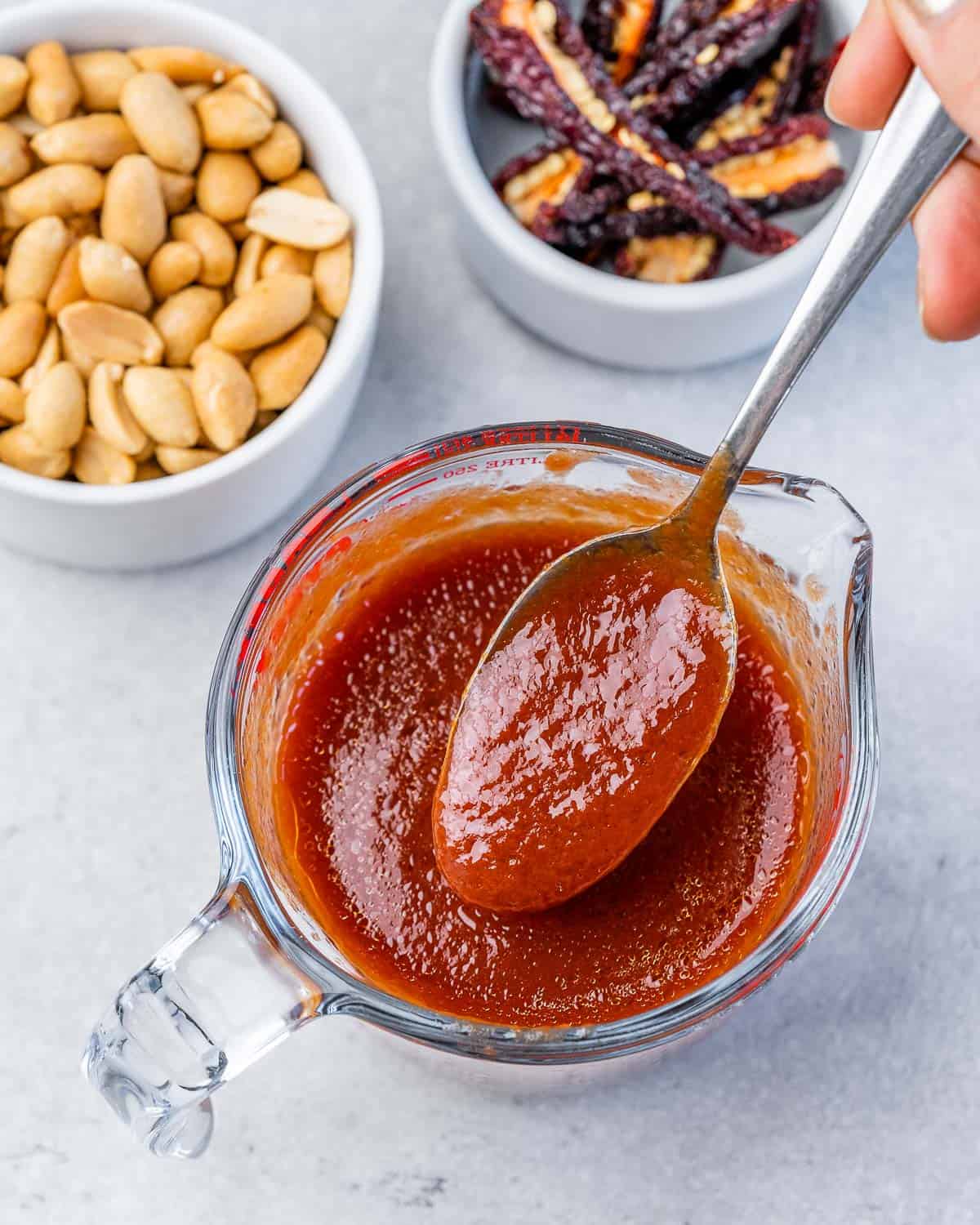 Mixing together sauce in a small bowl.