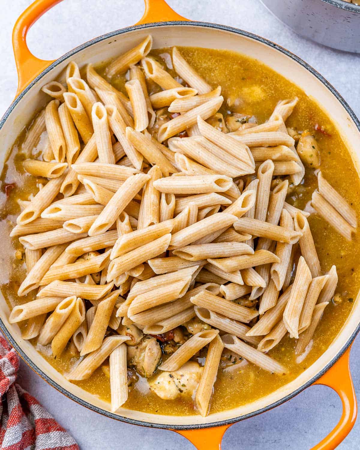 cooked pasta added over the creamy chicken sauce