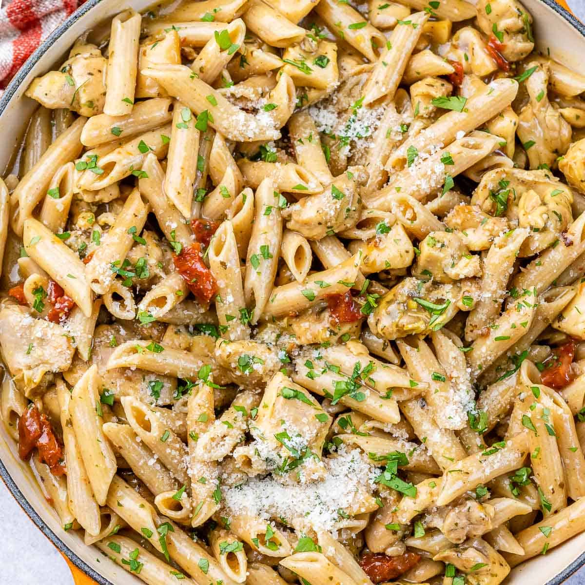 top view of creamy penne pasta with chicken and sun-dried tomatoes