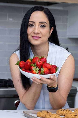rena holding a bowl of strawberries