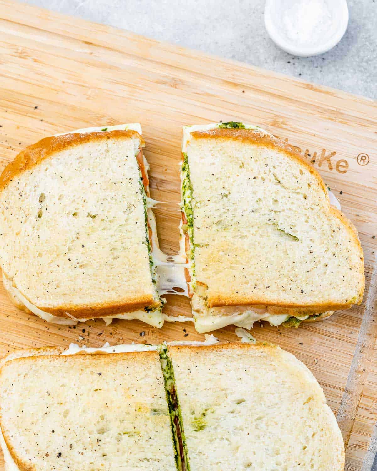 Sliced air fryer grilled cheese on a cutting board.