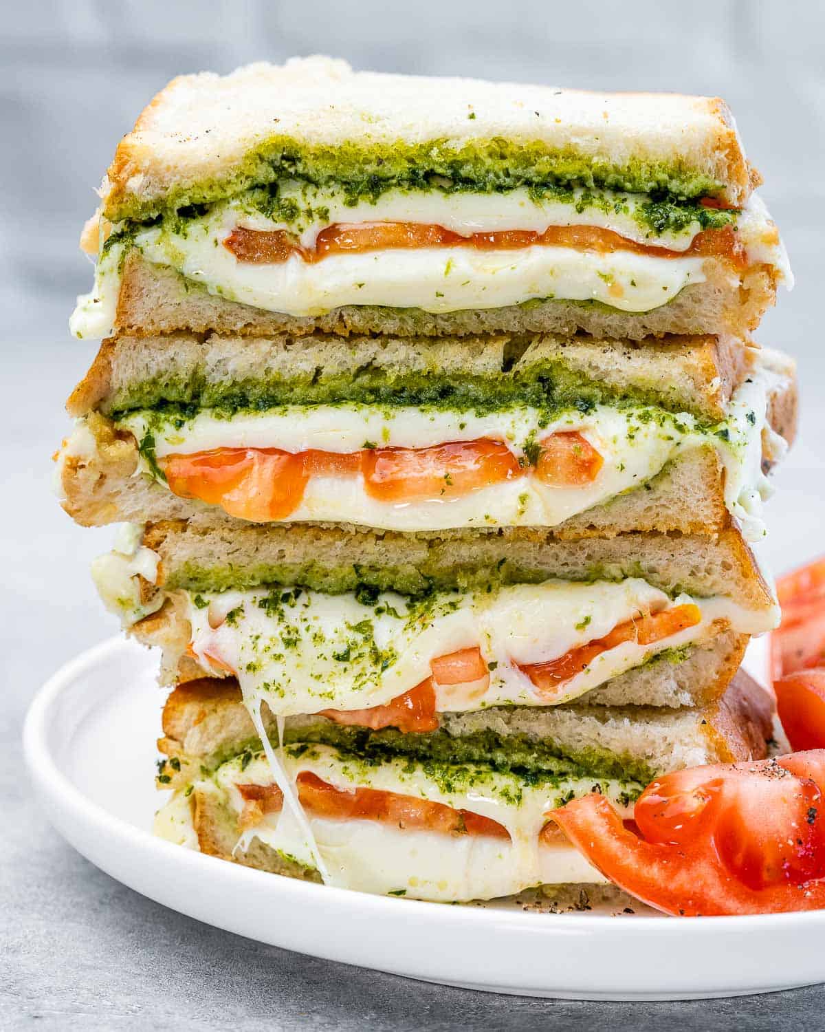 Air fryer grilled cheese stacked on the white plate.