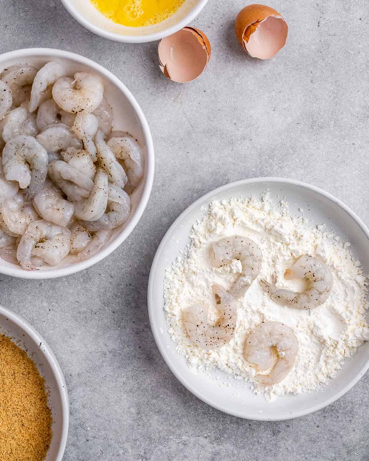 Tossing shrimp in flour.