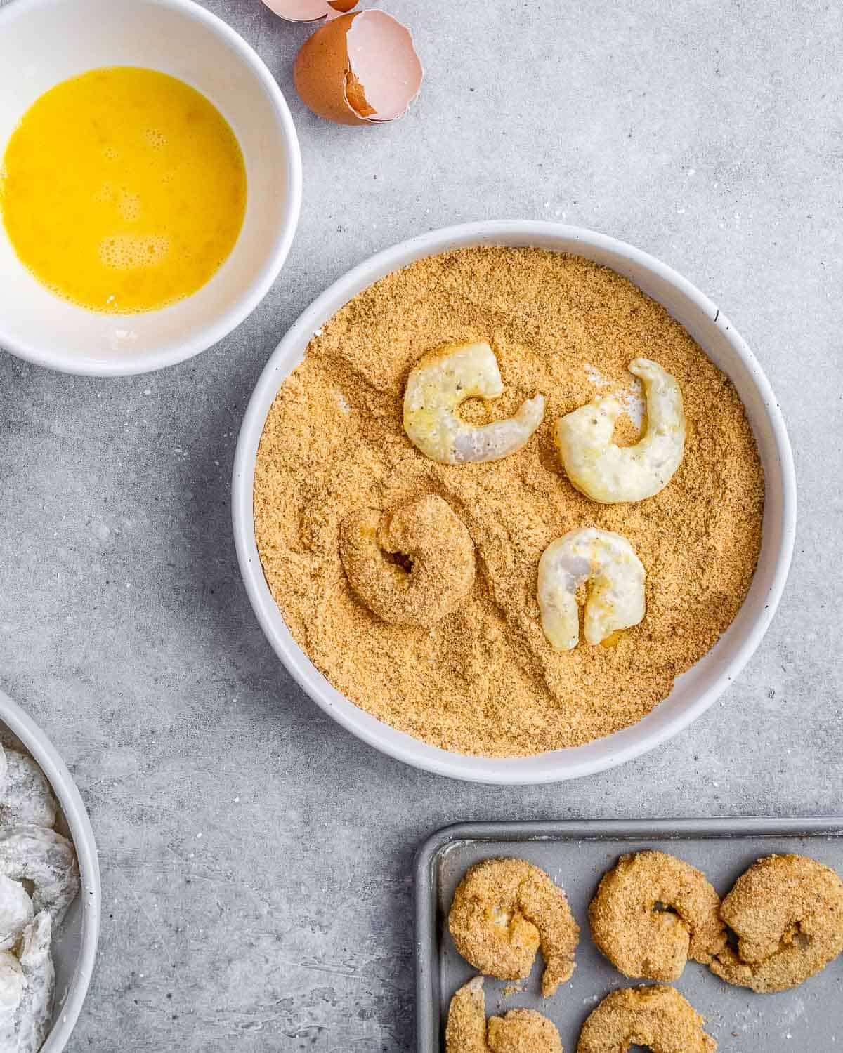 Dredging shrimp in breadcrumbs.