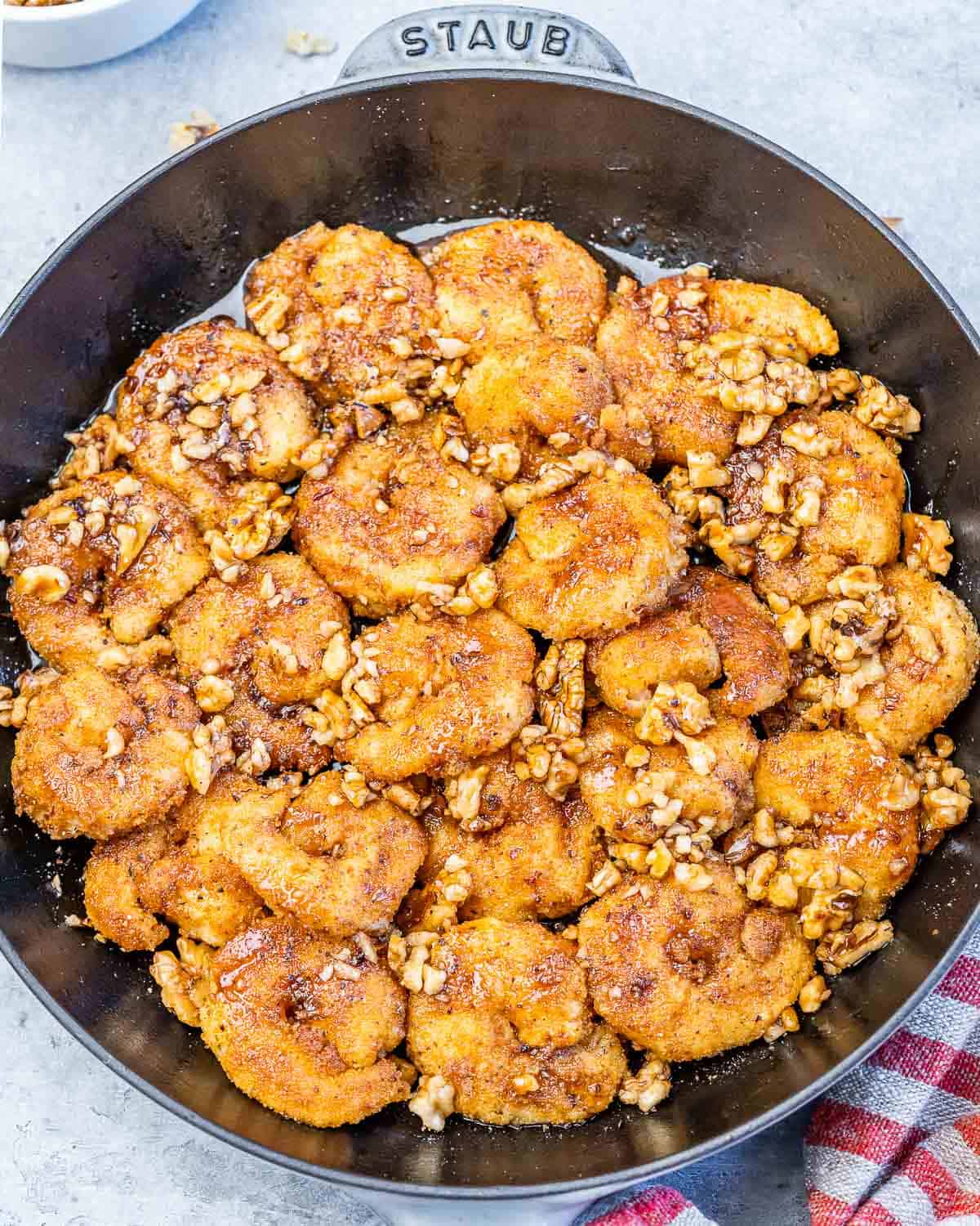 A black skillet with honey walnut shrimp.