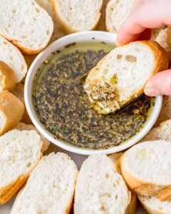 bread dipped in the seasoned oil in a bowl.