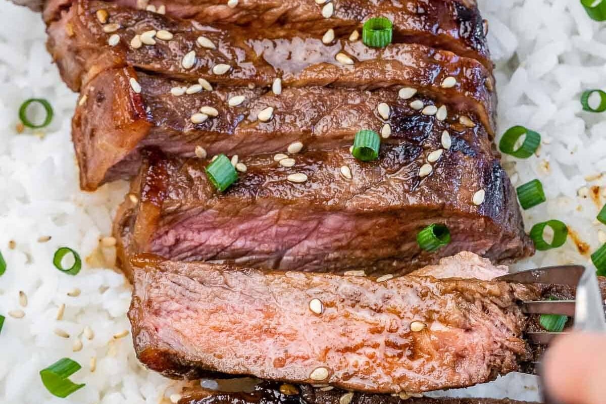 Sliced teriyaki steak served over rice.