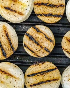 Grilled onion slabs in a pan.