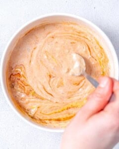 mixing the in n out sauce in a bowl.
