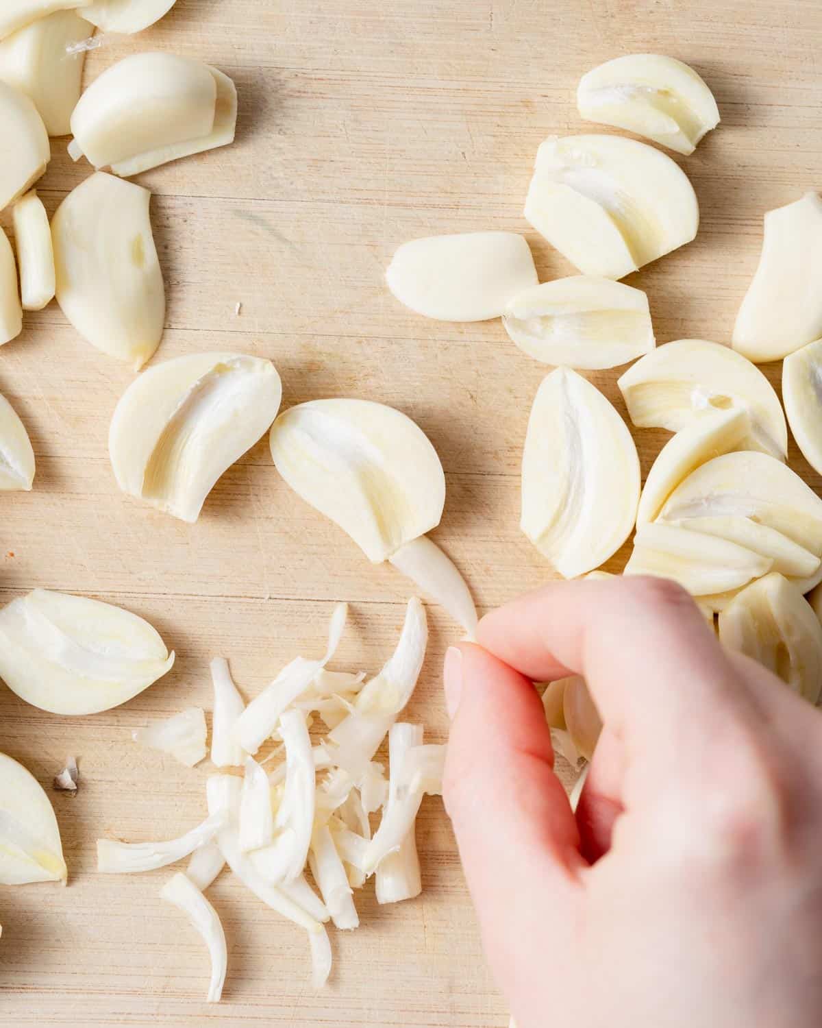 fresh garlic sliced on a cutting board.