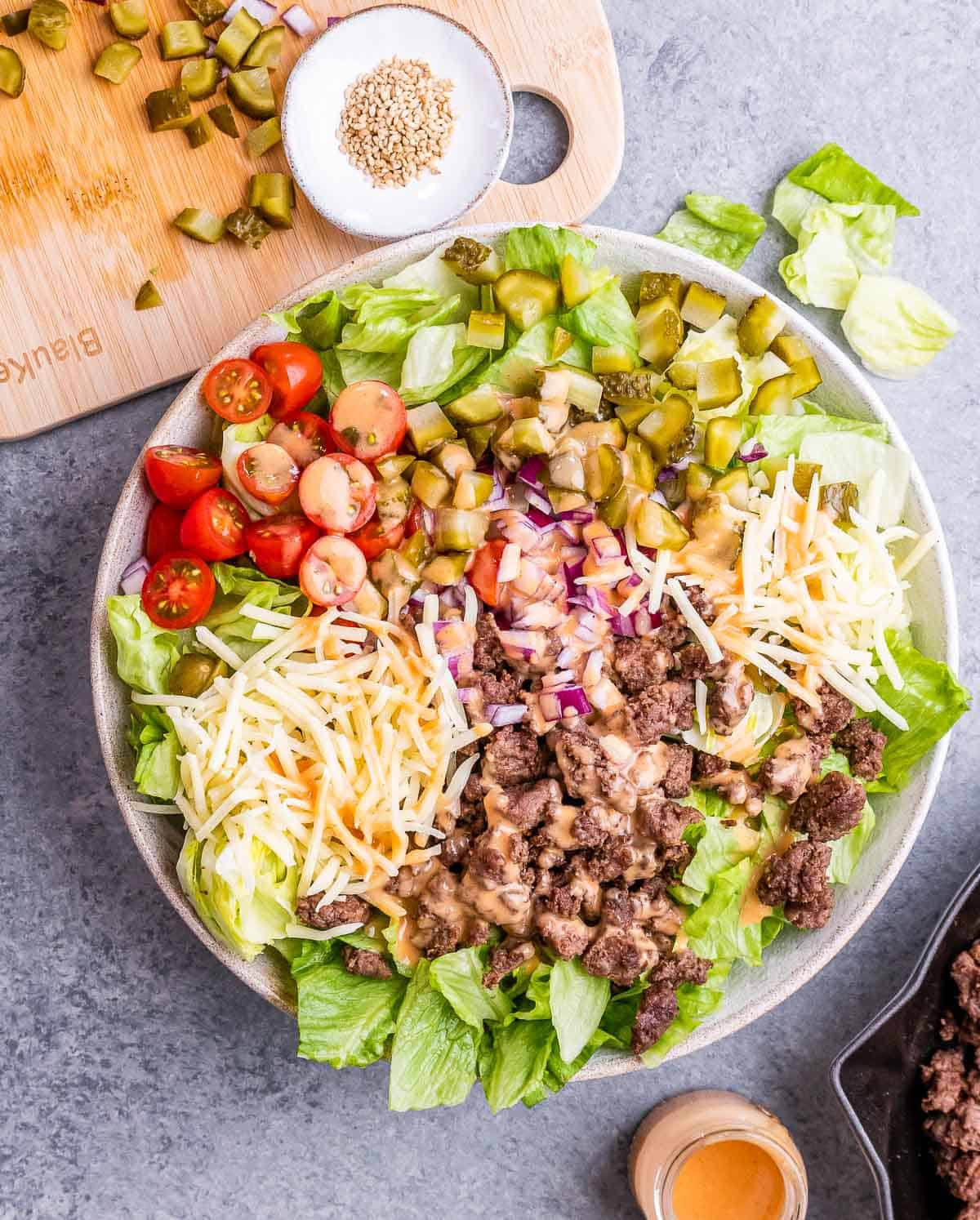 Big Mac salad that's made with minced meat, lettuce, tomatoes, and pickles.