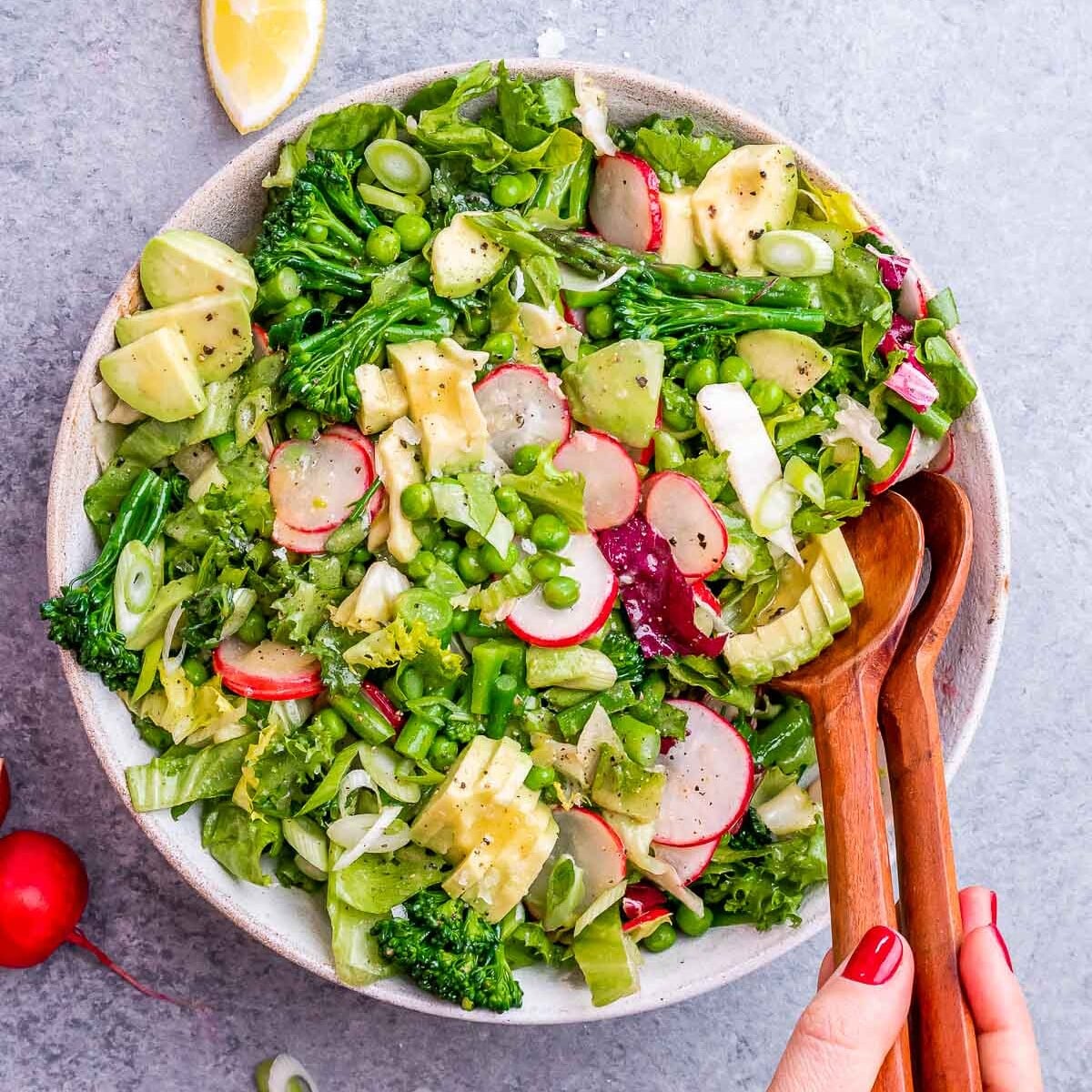 Salad tongs in a spring mix salad.