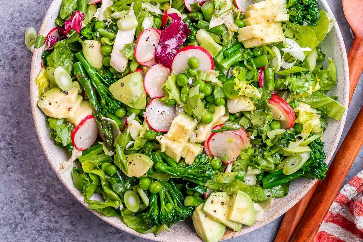 a bowl filled with spring mix salad.