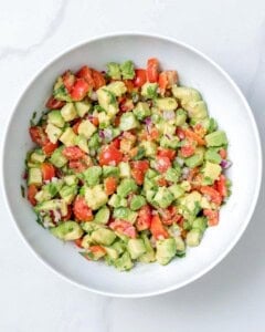 salsa made with avocado and tomatoes placed in a bowl.