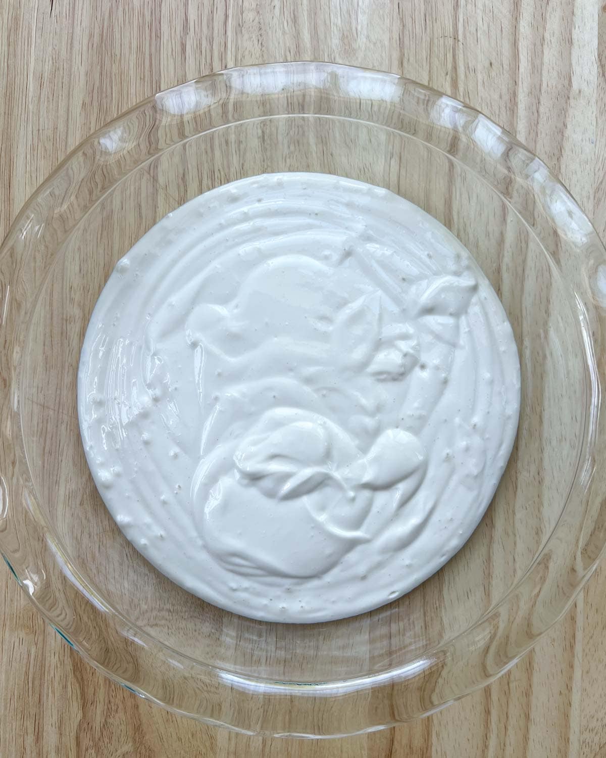 blended cottage cheese is added to a round deep dish.