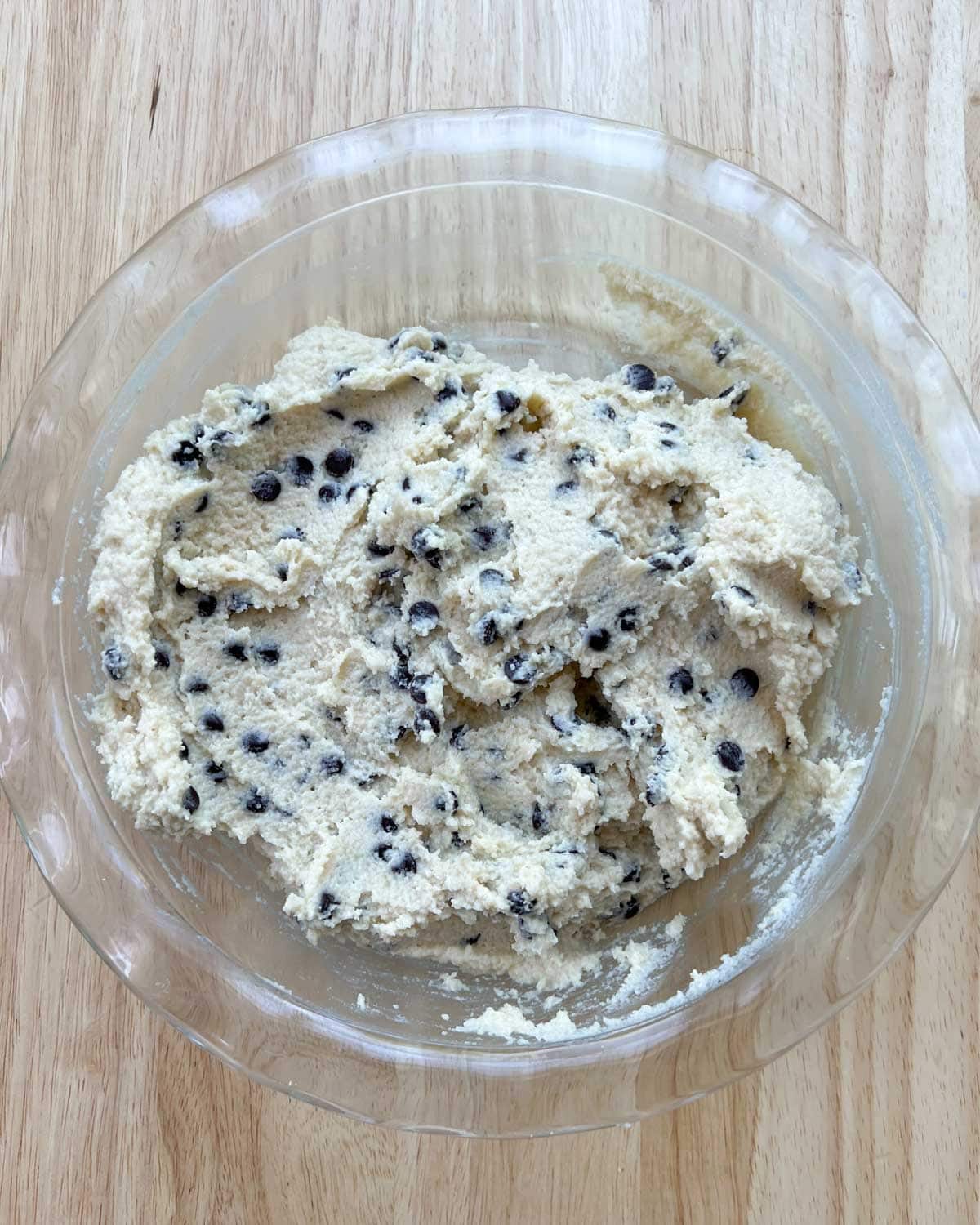 chocolate chips blended in with the dough in a round dish.