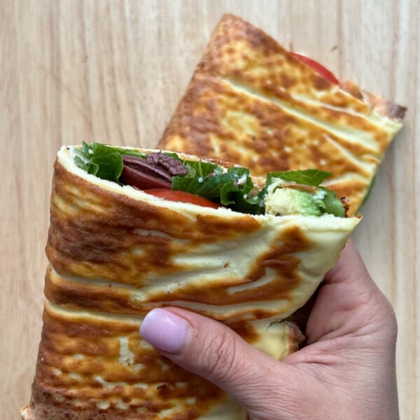 hand holding half a sandwich wrap.