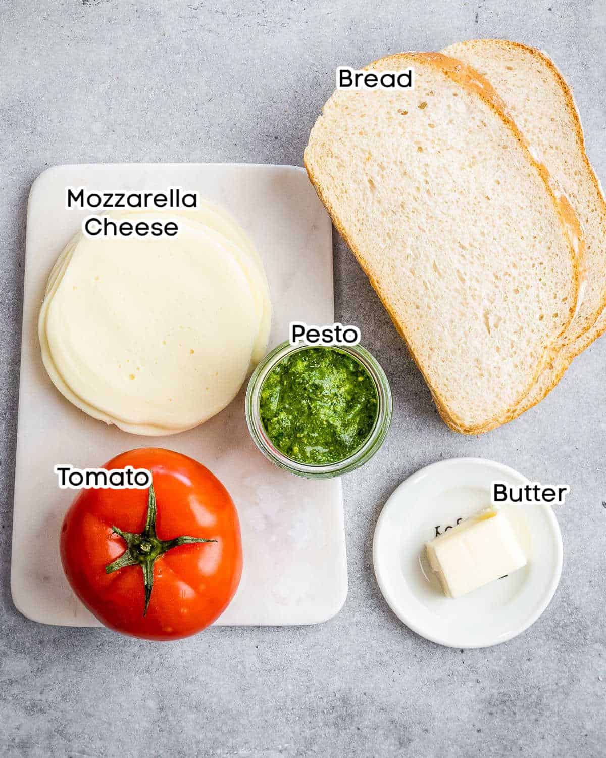 ingredients to make grilled cheese with pesto and tomatoes.