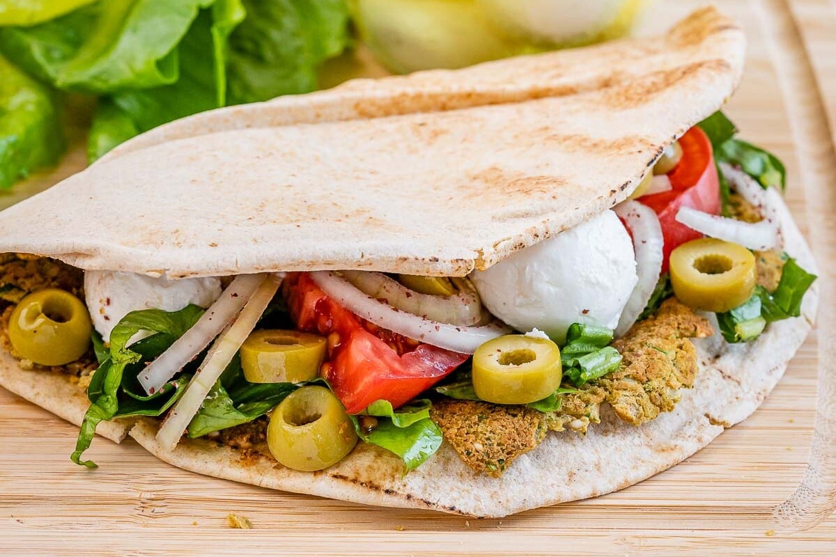 smash falafel pita on a cutting board.