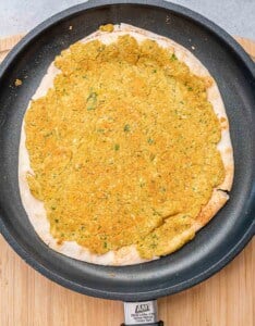 falafel on pita cooked in a pan.