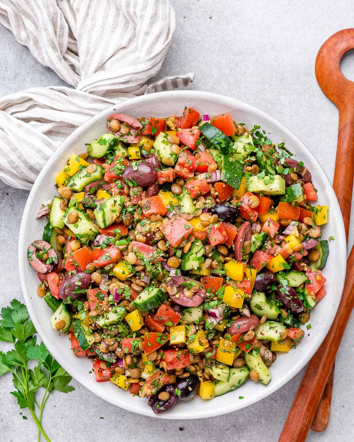 A mixed veggie with lentil salad in a round bowl.