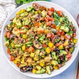 A mixed veggie with lentil salad in a round bowl.